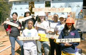 A group of student volunteers from the Hotchkiss School in Connecticut pose with homeowner Yolanda Ferguson during construction on a Habitat for Humanity house in Pickens. Rocky Nimmons/Courier