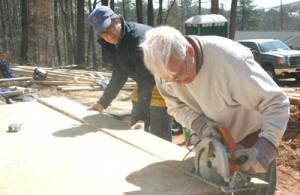 Rocky Nimmons/Courier Tom Seley of Pickens County Habitat for Humanity, right, works with Greg Lark of the Hotchkiss School during construction last Friday on a house in Pickens.