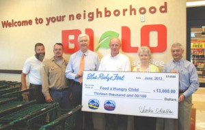 Feed A Hungry Child — From left, Blue Ridge Electric Cooperative Inc. employees Tony Kelley, Bryan Roper and David Collins are joined by Blue Ridge Fest sponsors Eloise Hiott of Hiott Printing, (also representing Representative Davey Hiott), and Richie Tallman of Bi-Lo of Pickens as they present $13,000 to Feed a Hungry Child. Accepting on behalf of the charity is Mike Parrott, who serves as treasurer of the board.