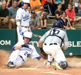 S.C. District 1’s L.T. Tolbert slides safely into home to score a run past Texas catcher Gavin Grissom during District 1’s 15-5 tournament-opening win last Wednesday in Easley. The host team finished this year’s Big League World series with a 2-2 record. (Kerry Gilstrap/Courier)