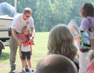 Hadley Cooper gets fitted for a life jacket by SCDNR officer Gabriel Gilmore. 