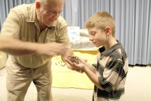 Cody Teague holds a tarantula during the Critter Keeper presentation at the World of Energy. 
