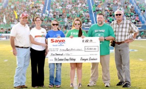 Kerry Gilstrap/Courier Officials and students pose with a check from Save-A-Lot of Pickens owner Dwayne Goodwin, left, to Pickens County Meals on Wheels at the annual Food Fight Bowl on Friday night.