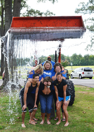 Members of Southern Wesleyan University’s admissions staff grimace as they are drenched by more than a hundred gallons of ice water as part of the ALS Ice Bucket Challenge. When the department was challenged, they took things up a notch with a little help from the university’s grounds crew. The challenge is raising awareness and support for the ALS Association in its fight against the illness known as “Lou Gehrig’s Disease.” Pictured from left (front) are admissions counselor Jared Trudel, office manager Donna Wood, admissions counselor Stephanie Rodriguez, (back) assistant director of admissions Melissa Vess, director of admissions Amanda Young and admissions counselor Emily Bloxdorf. Operating the front-end loader is landscape manager Byron Shirley.