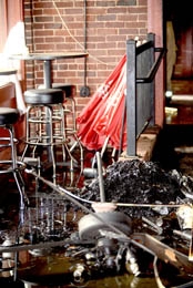 Kerry Gilstrap/Courier A fallen ceiling fan and other burned debris is pictured inside Michael’s Pizzeria, which was destroyed by fire in Easley on Monday. 