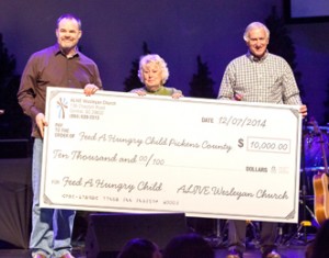 Pictured from left are Rev. Tom Harding of ALIVE Wesleyan, along with Kathy Brazinski and Milledge Cassell, co-founders of Feed a Hungry Child. 