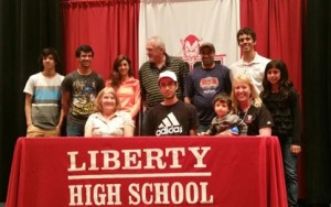 Liberty High School’s Abe Balawi recently signed his national letter of intent to continue his running career at Mercer University. Pictured are Mismeh Balawi, Adam Balawi, Hanan Balawi, Tim Powell, Abdallah Balawi, Coach Patrick Canterbury, Maleah Balawi, Brenda Powell, Abraham Balawi, Gabriel Balawi and Shannon Balawi.