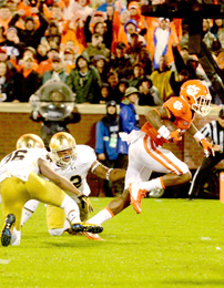 Kerry Gilstrap/Courier Clemson receiver Artavis Scott heads into the end zone for a touchdown after bouncing off two Notre Dame defenders.