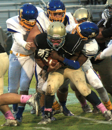 Rocky Nimmons/Courier Daniel’s Stephon Kirksey is wrapped up by a trio of Wren defenders during their game Friday at Singleton Field.