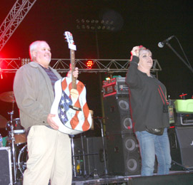 Susan Stansell and Art Maco announce the winner of the guitar raffle