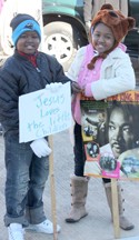 Rocky Nimmons/Courier Two children hold signs at a Martin Luther King Jr. Day ceremony in Pickens on Monday.