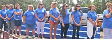 Jason Evans/Courier Teachers and staff line up to receive a special memento from the PTA — framed pictures of the school. 