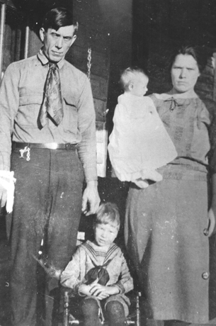 Baby Grace Moody, father, mother, and brother, Fred, at birth place.