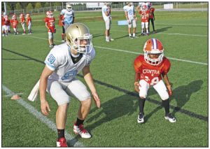 The 10-and-under Central Tigers got the chance to hit the practice field with the Daniel High School football team in the shadow of Singleton Field last Tuesday evening.  Rocky Nimmons/Courier