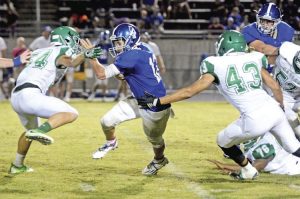 Kerry Gilstrap/Courier Pickens quarterback Tanner Stegall tries to squeeze between a pair of Easley defenders during their game Friday.